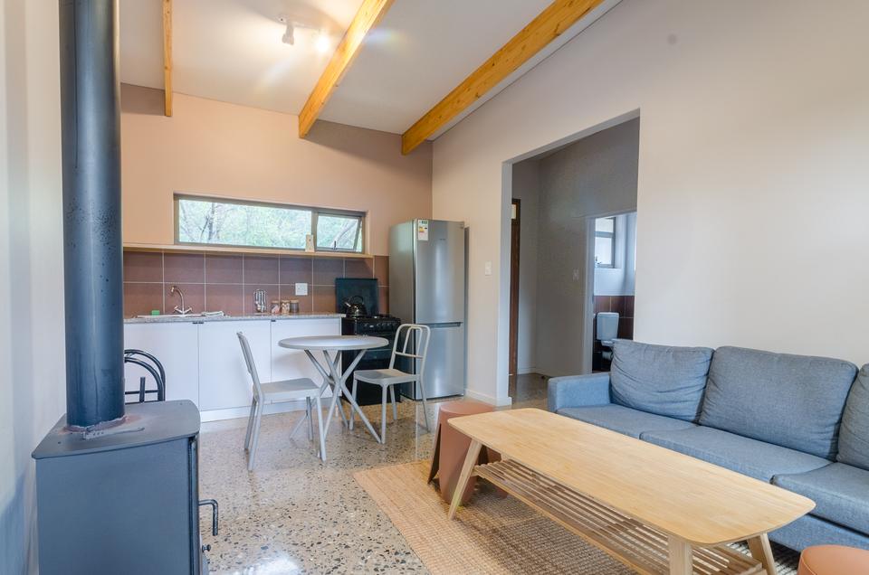 The open-plan living area and kitchen of a VIP cottage.