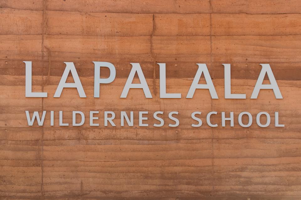 The Lapalala Wilderness School name on a rammed-earth wall.