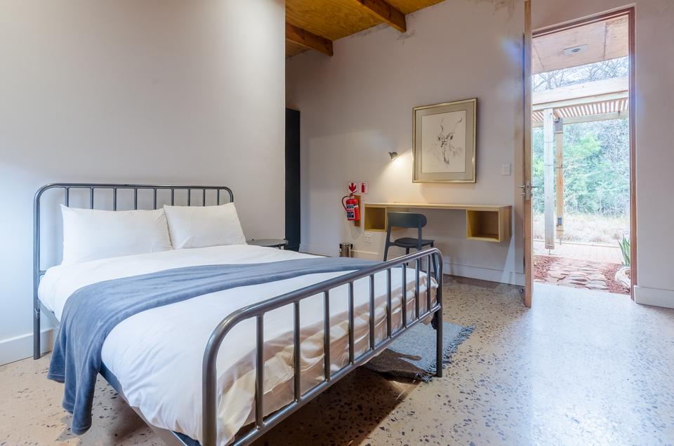 A single room with a double bed and a door onto the veranda.