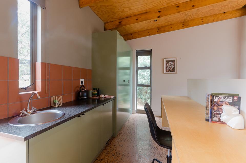 A kitchenette and desk in a VIP room.